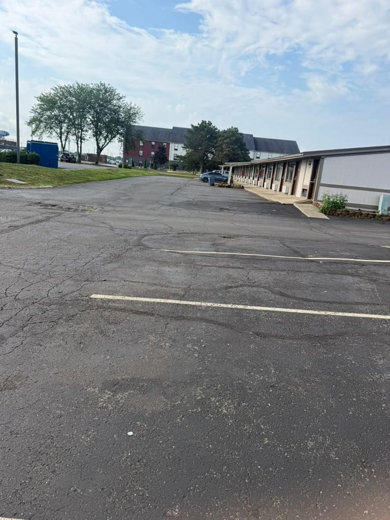 Expansive Asphalt Parking Lot and Exterior Guest Walkways